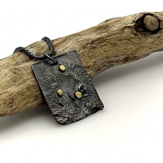 Oxidized silver rectangle necklace reticulated for texture and 3 dots of 18K gold that are like fireflies in the night.