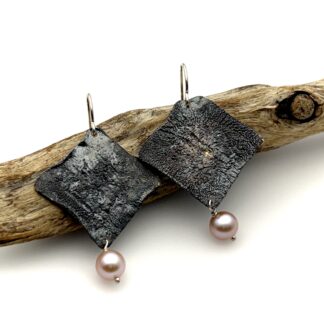 Pink pearl dangle earrings with reticulated oxidized silver diamond shapes.