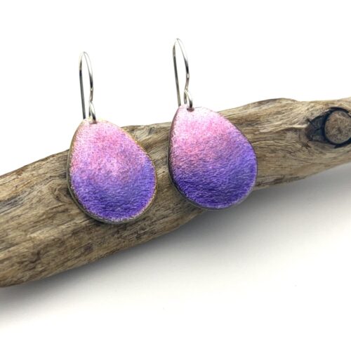 Silver dangle earrings with water drop shapes of fine silver covered in layers of hot pink and purple enamel with 925 sterling silver ear wire.